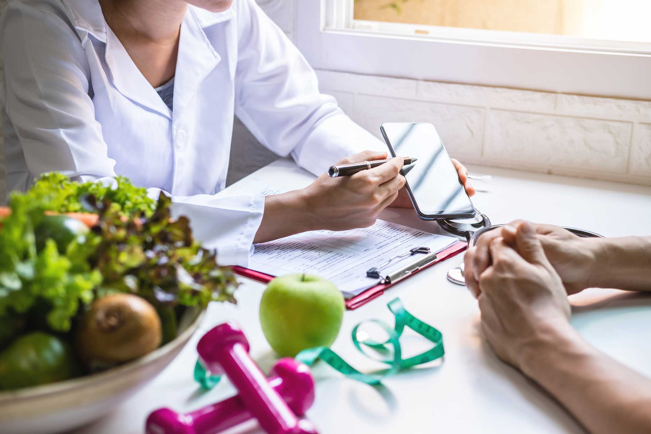 Doctor providing weight management assessment